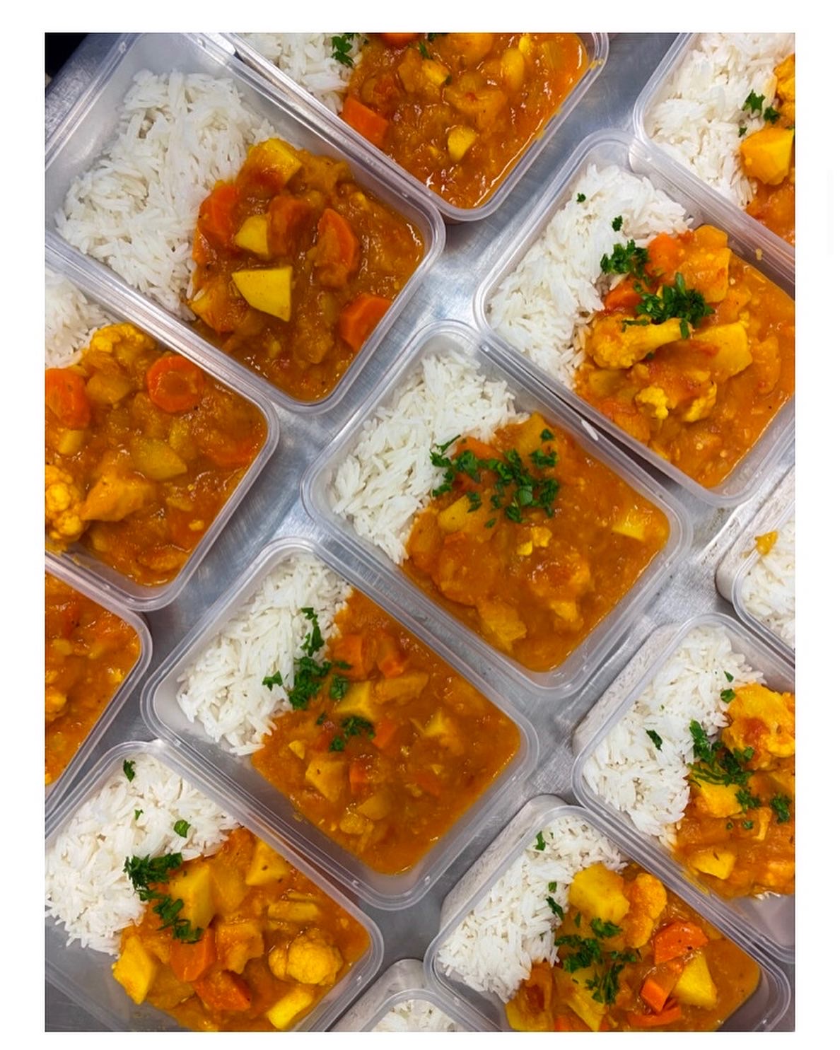 curry and rice laid out in tupperware boxes, viewed from above